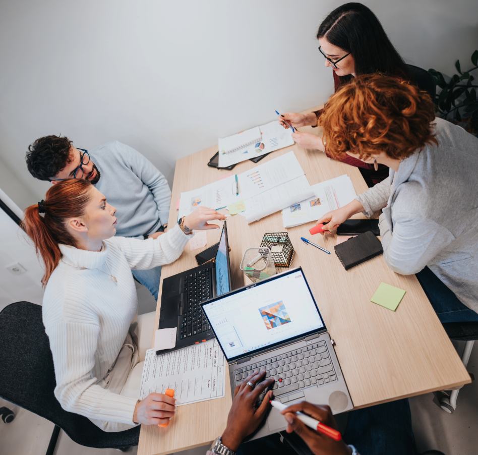Team collaborating around a workspace table